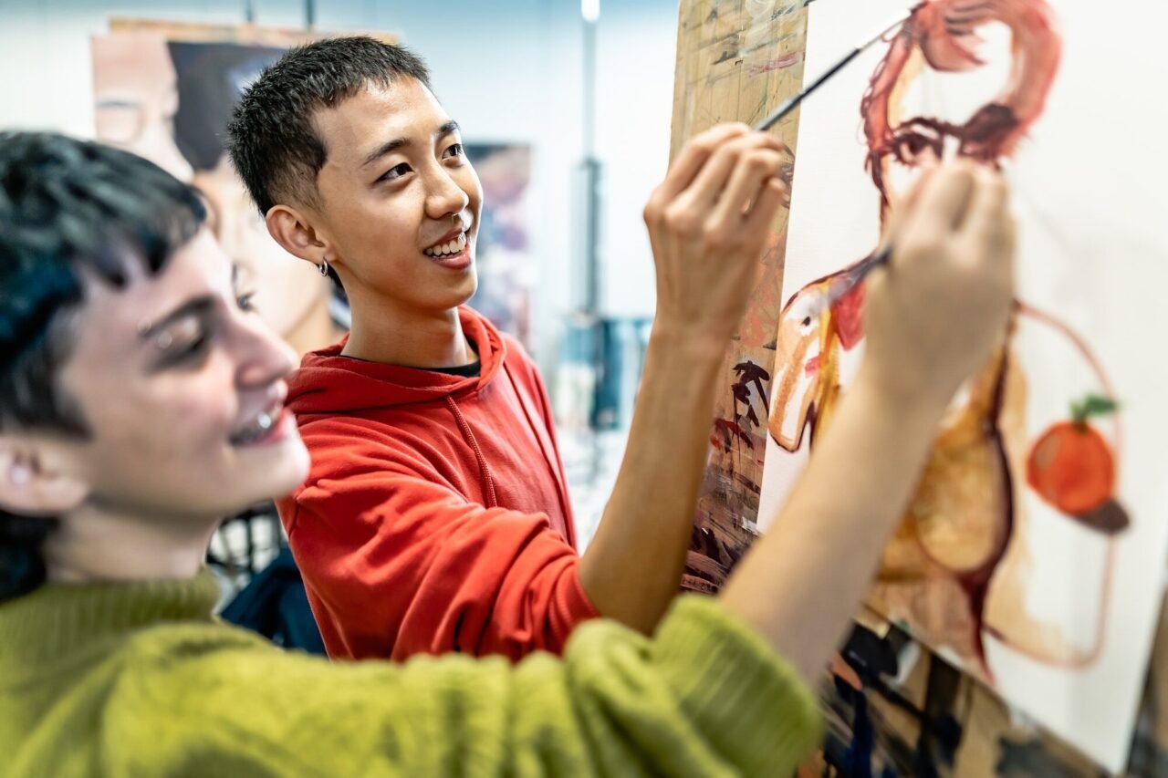 Young students painting on canvas during an art lesson at Abundant Life